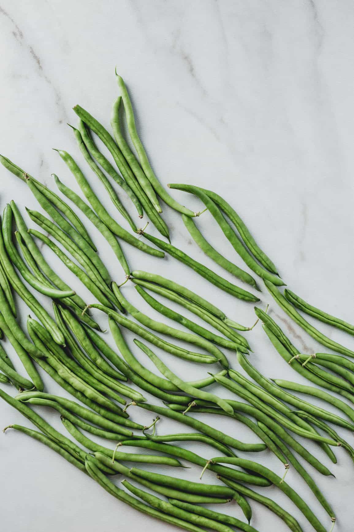 Green beans on a marble background